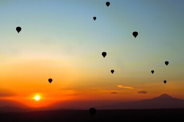 Flying in a hot air balloon as the sun rises over Cappadocia