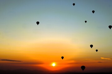 Flying in a hot air balloon as the sun rises over Cappadocia