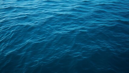 Obraz premium A breathtaking high-resolution image showcases the deep blue ocean water with gentle waves creating a serene and tranquil seascape.