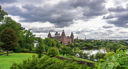 Scenic view of Johannisburg Castle in Aschaffenburg, Germany, surrounded by lush greenery under...