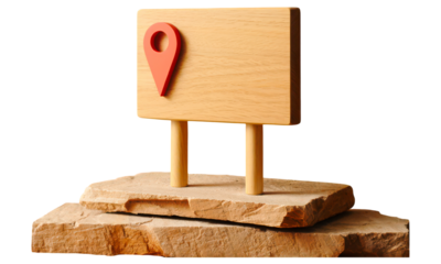 Wooden signpost with a red location pin on a stone base isolated on a transparent background