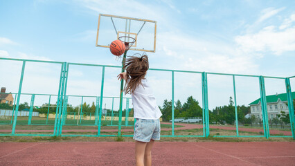 Girl shooting basket ball, playing basketball on sport court
