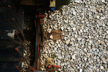Bottom view of vintage trains connection pipes and gravel on narrow-gauge tracks, Mokra Gora, Serbia.