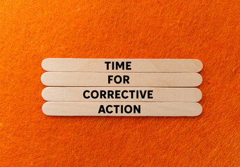 Time for corrective action message written on wooden sticks on orange background. Conceptual time...
