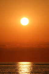 Beautiful sunset over the sea. The sun goes down over the sea. Sunset over the sea with orange sky...
