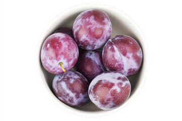 Obraz premium a bowl of plums on a white surface