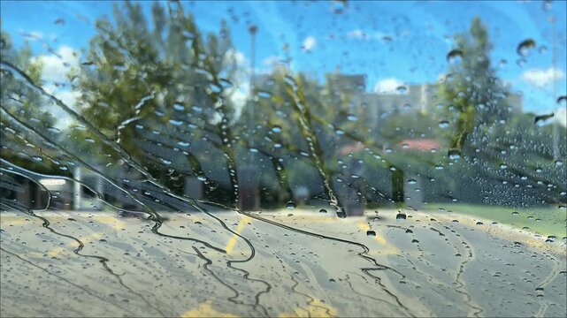 streams of water on the windshield, view from the car interior on the windshield when washing the car