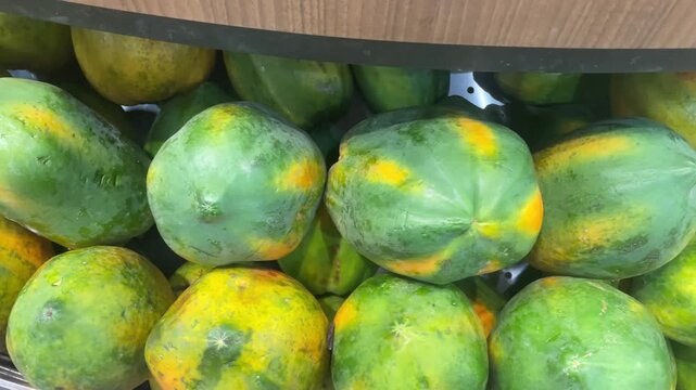 Fresh pappaya in Market Display &ndash; Ripe and Unripe Fruits Stacked