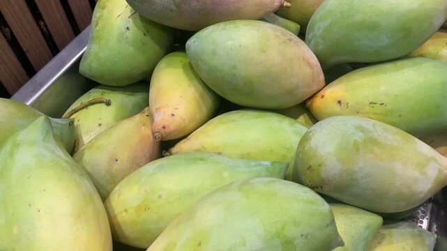 Pile of Fresh Raw Green Mangoes in Market Display