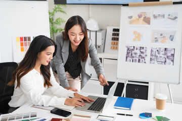 Asian female interior designer or architect working on creative project with drawing, material...