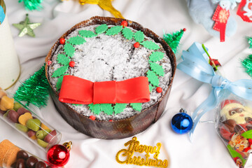 Christmas cake with Christmas props around. 