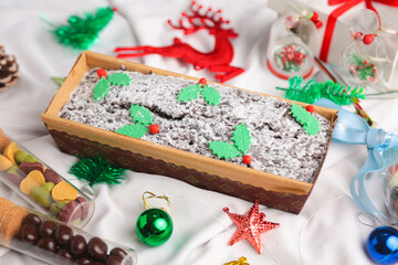 Christmas cake with Christmas props around. 