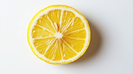 Isolated lemon wheel on pure white surface, perfect for food, drink, or wellness-themed imagery