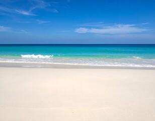 Fototapeta premium Pristine seashore with azure water meeting soft sand under a clear sky scape