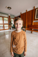 Portrait of smiling child standing in corridor of building