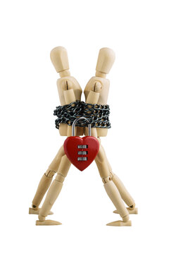 Abstract, Symbol Two wooden puppets or manikin love and unhappy are chained together by red heart-shaped padlock. Material creative idea photo love concept. Isolated white background with transparent.