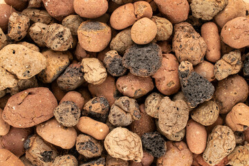 Pebbles for drainage in pots of houseplants, macro, top view.