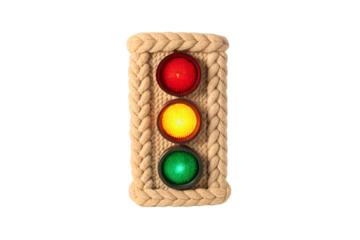 Rope-wrapped traffic light with braided edges and three colored illuminated signal lenses, isolated on a transparent background