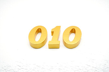 The numbers are made of gold-painted wood, placed on a white background.