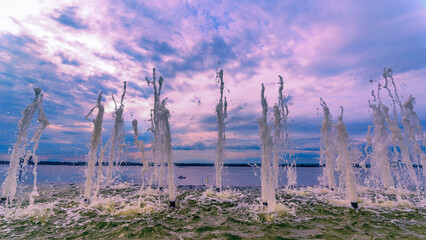 original fountain on the embankment near the boat in the city on the Volga River