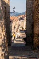 downhill street of the old village at sunset - Rocca Cilento - Salerno - Italy