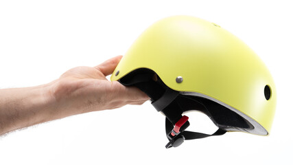 Bright yellow helmet held by a hand indoors