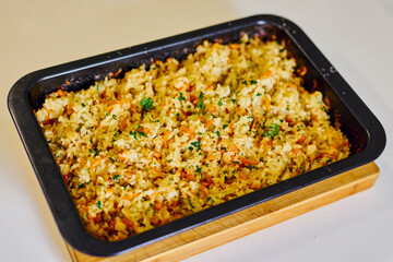 rice with vegetables in a tray on a table