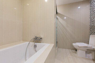 Bathroom featuring wall tiles, a white toilet