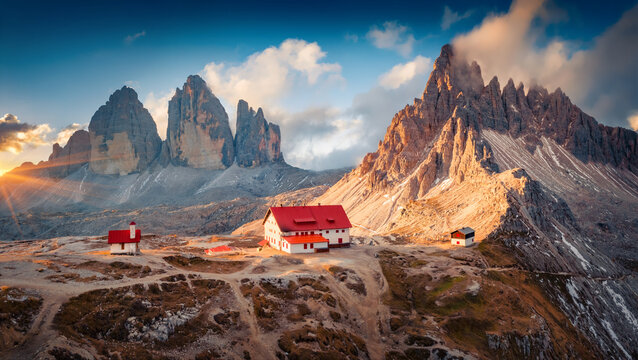 Fototapeta Fantastic summer sunrise on Dolomites with Paternkofel and Tre Cime Di Lavaredo mountain peaks on background, Italy. Wonderful morning scene of Italian Alps. Beauty of nature concept background.