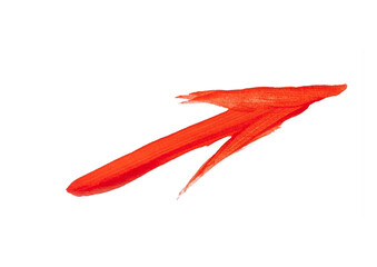 A vibrant red, hand-painted arrow with a dynamic curve, pointing diagonally downwards and to the right on a light grey background.