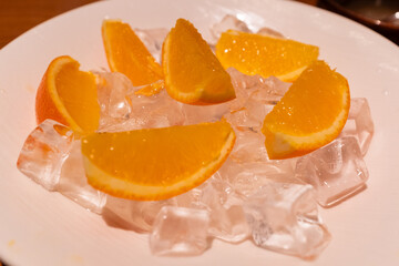 Iced fresh orange on white plate