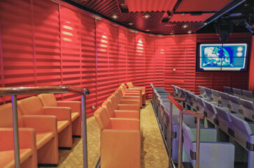 Colorful show Lounge or theatre studio with stage and seating in modern design on cruiseship or...