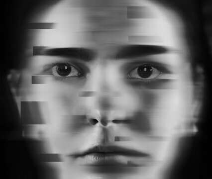 A woman's face closeup with disturbed expression glitch art abstract in black and white