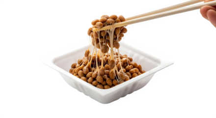 Capturing the unique stringy texture of fermented soybeans with chopsticks, a traditional Japanese superfood delight ready to be savored.
