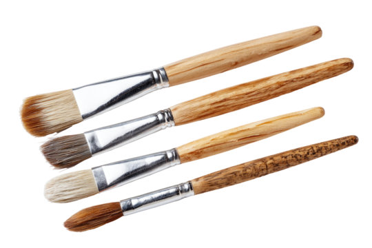 Close-up of five paintbrushes, various shapes and shades of light brown wooden handles, metal ferrule