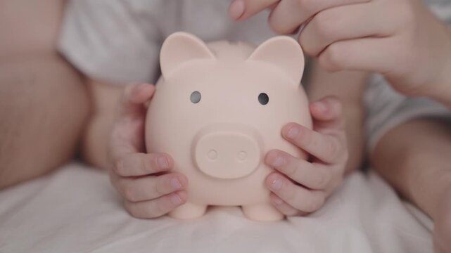 budget of a happy family, a hold on the future of life, a family security pillow, a pig piggy bank collects money, father and mother give cash a child, the concept of a child's dream of saving coins.