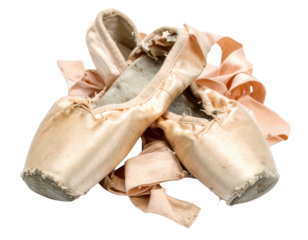 Worn ballet shoes with ribbons, showcasing their delicate design and age, reflecting the artistry of dance.