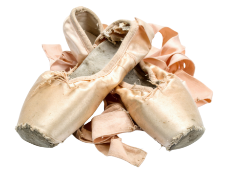 Worn ballet shoes with ribbons, showcasing their delicate design and age, reflecting the artistry of dance.