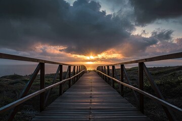 Fototapeta premium Wooden pathway leading to a vibrant sunset