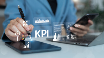 Close-up hand using a stylus and smartphone with a holographic KPI dashboard interface, showing charts, analytics, and performance metrics for business strategy tracking.
