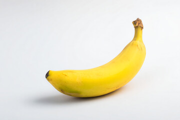 a single banana on a white surface