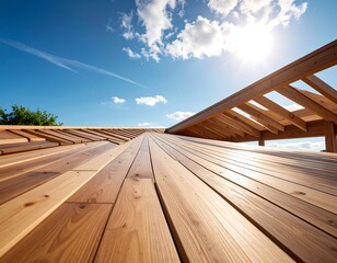 Wooden structure under construction against a bright blue sky with clouds and sun