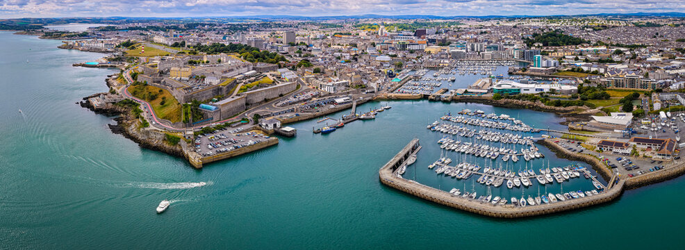 Aerial view of Plymouth Hoe and Royal Citadel along the waterfront in Plymouth, England, with cityscape and marina in the background