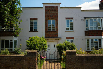 Facade of a charming residential house with garden in Chiswick, London.