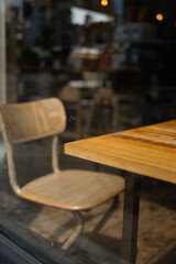 Empty wooden chair and table inside a cozy café in Chiswick.