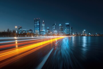 City skyline at night, with a highway of blurred car lights