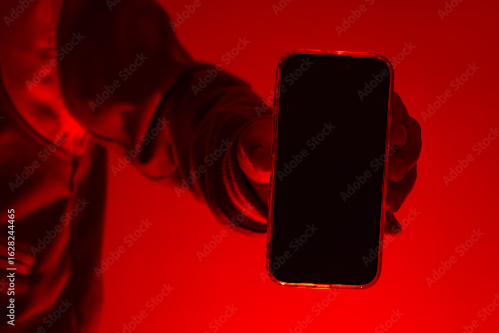 Poster modern smartphone in a man's hand with a close-up mockup of the screen. the man holds the device und