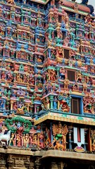 Intricately sculpted gopuram (tower) of Azhagar Temple, a historic Dravidian-style Hindu temple in...