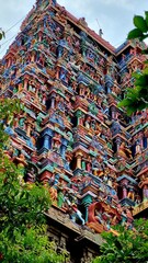 Intricately sculpted gopuram (tower) of Azhagar Temple, a historic Dravidian-style Hindu temple in...