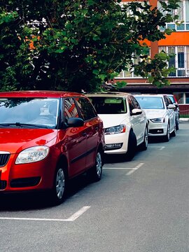Row of Parked Cars on Urban Street near Residential Building